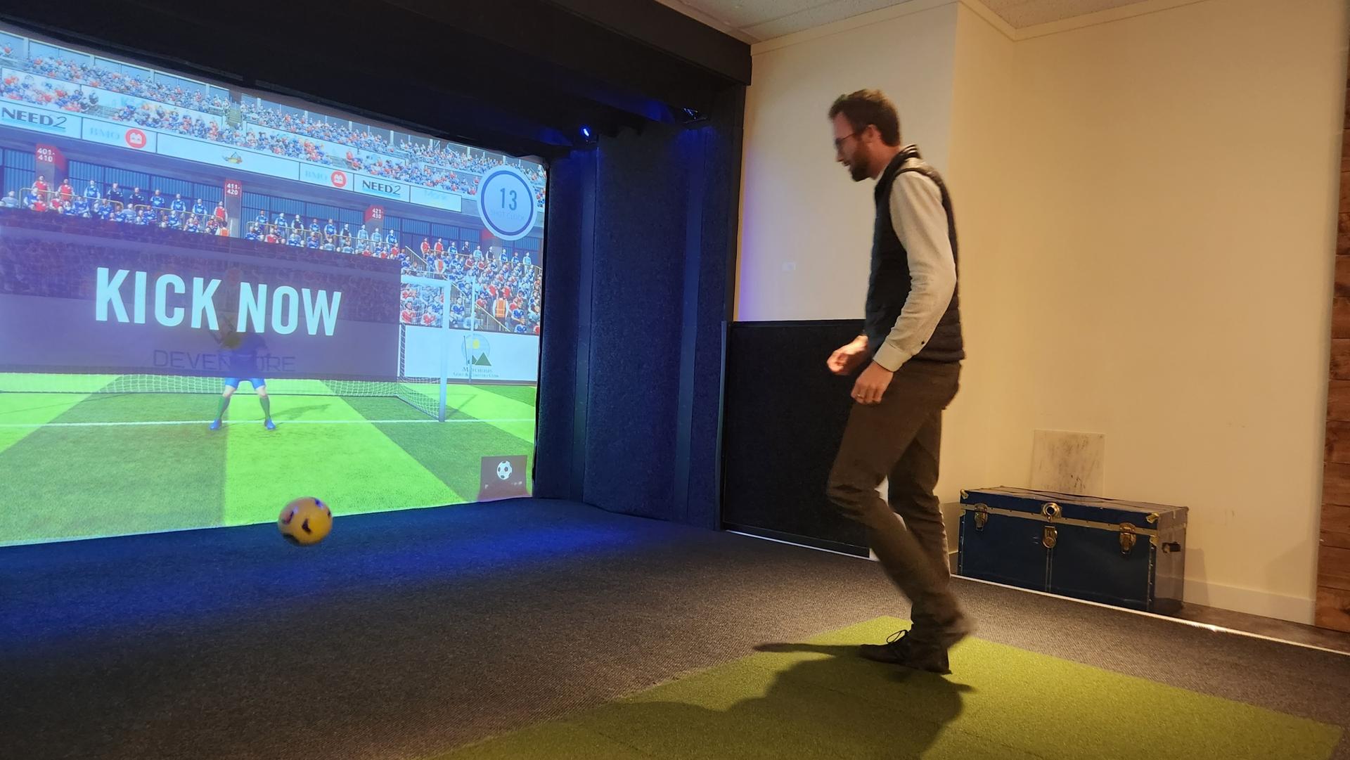 Playing soccer at Iron & Wood Golf Simulators