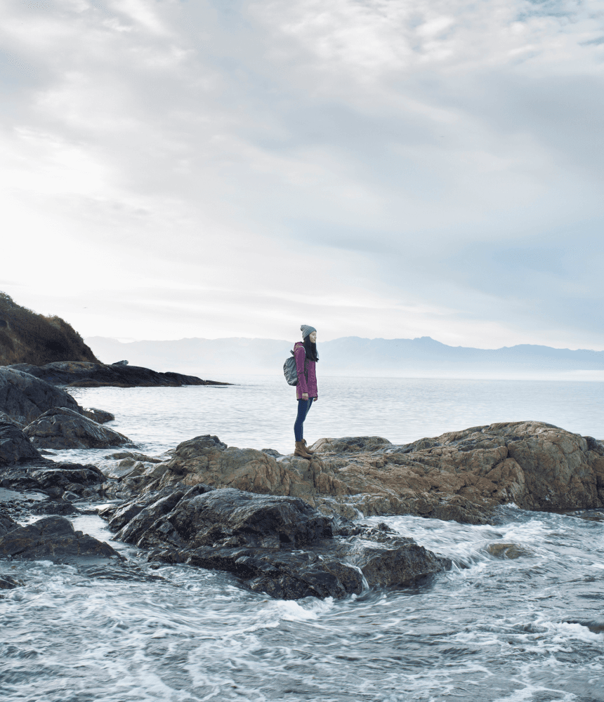 A woman on a rock on Dallas Road Beach