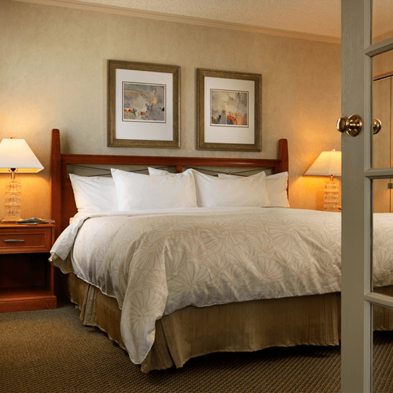 The Soft White Sheets of a Luxurious Bed in a Room at the Chateau Victoria