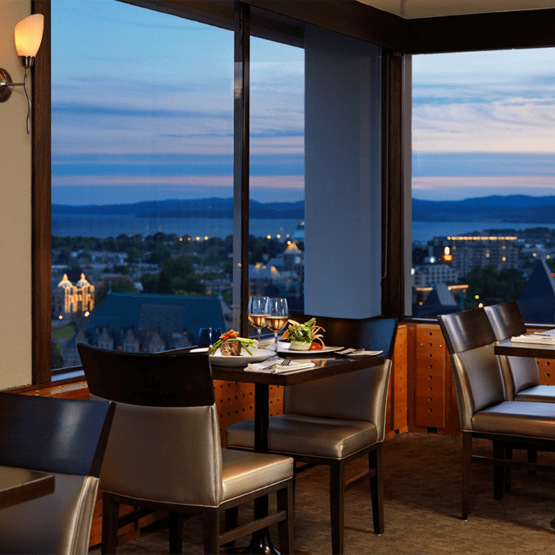 Vista 18 table with food and wine on it overlooking the harbour