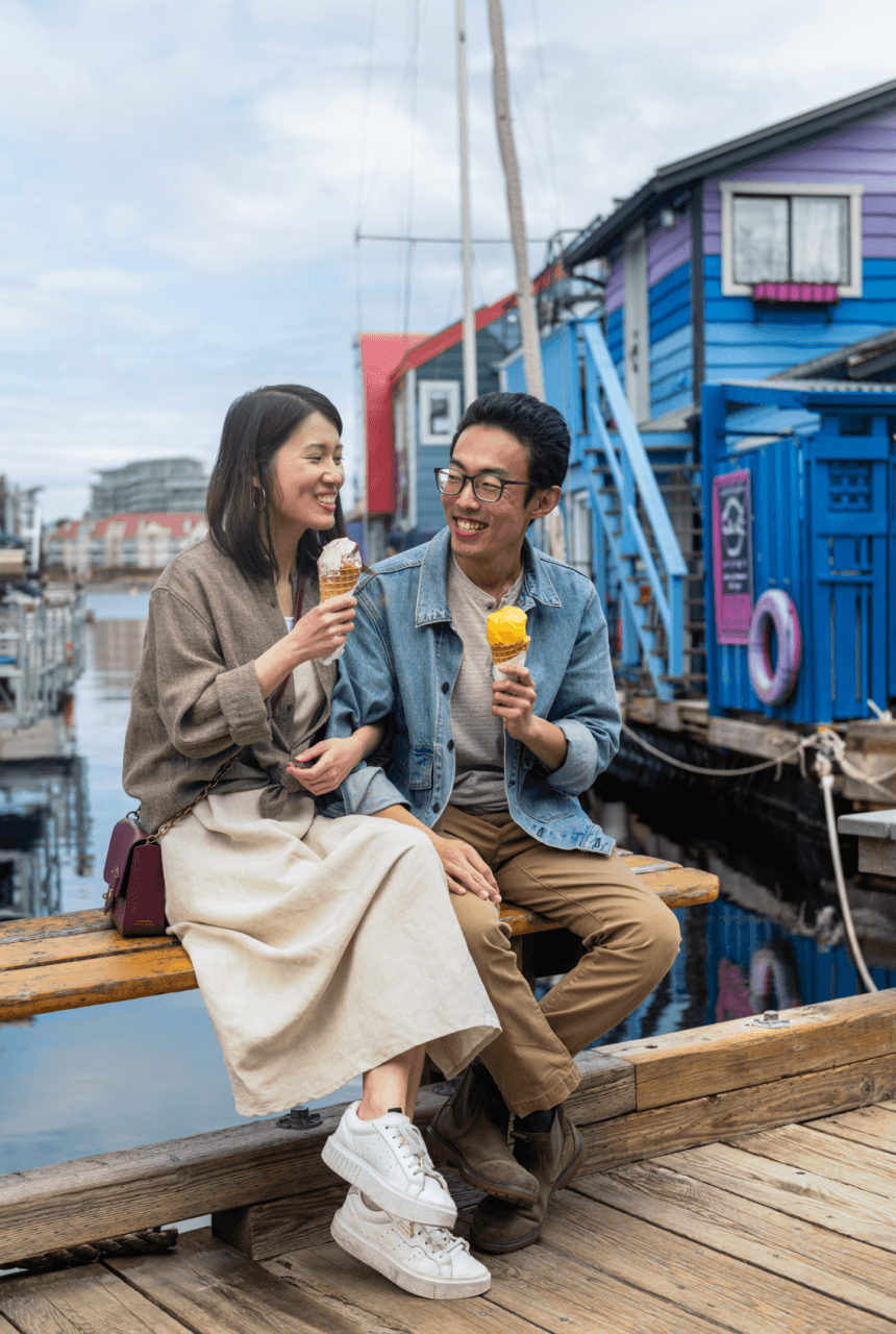 A couple enjoying ice cream on Fisherman's Wharf in Victoria, BC