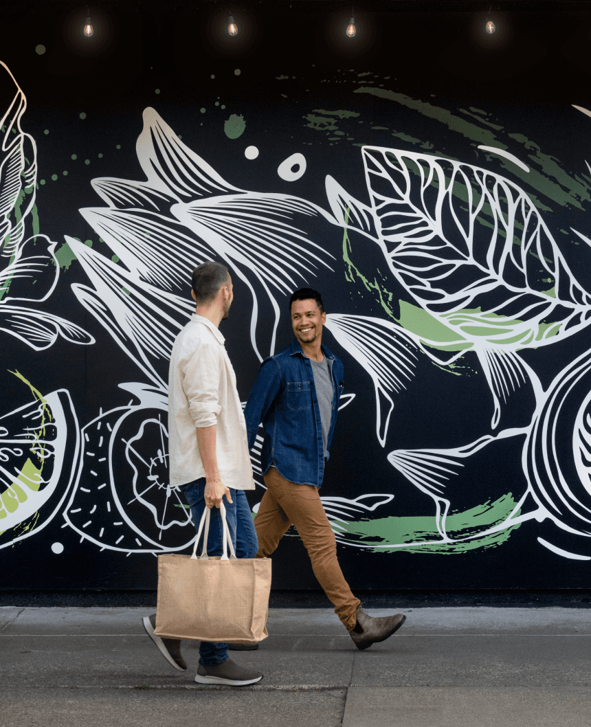 A couple explores Cook Street Village in Victoria, BC