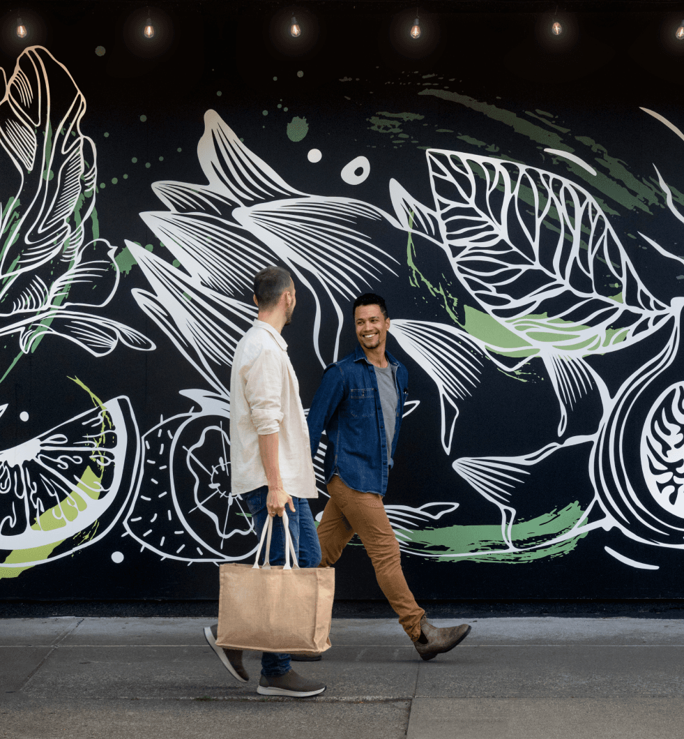 A couple walking Cook Street Village in Victoria, BC