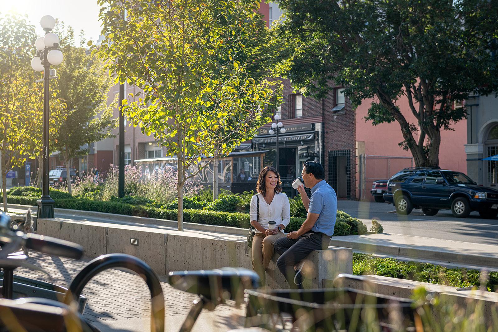 A couple sitting on a bench at Sherwood in Victoria, BC