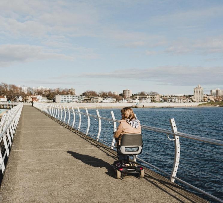 A person in a wheelchair on the Ogden Point Breakwater